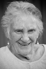 Portrait of smiling elderly lady in black and white
