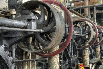 Central shaft driven by belt in old colonial factory, Java, Indonesia