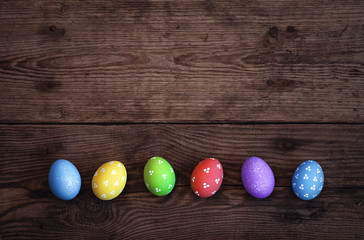 Easter eggs on dark rustic wooden background. 