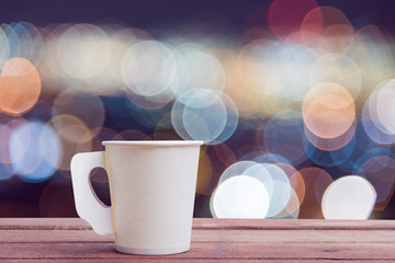 Paper cup coffee on the wooden table