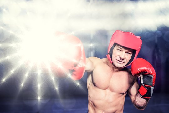 Composite image of boxer punching against black background