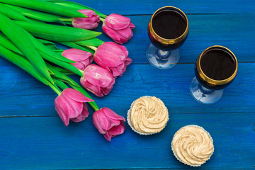 two glasses of red wine and tulips