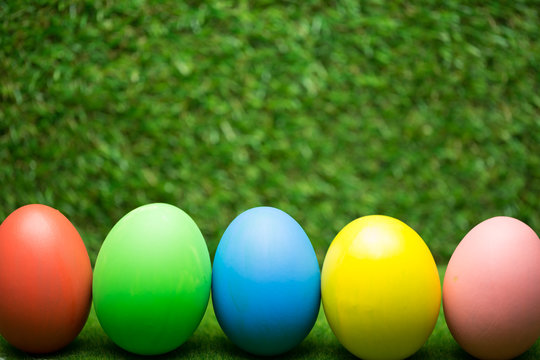 Row of Easter eggs on grass