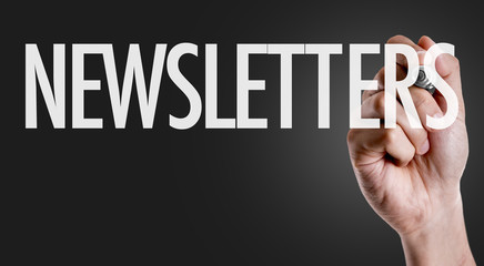 Hand writing the text: Newsletters
