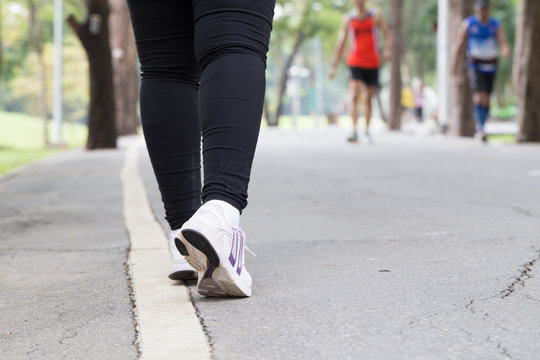 Closeup of leg of woman jogging in park