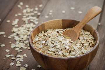 Oat flakes in wooden bowl
