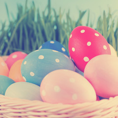 Fototapeta na wymiar Easter eggs in basket on meadow