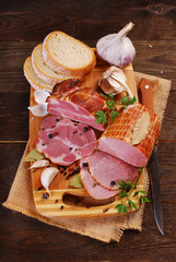 pieces of fresh smoked ham on rural background