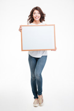 Happy woman holding blank board