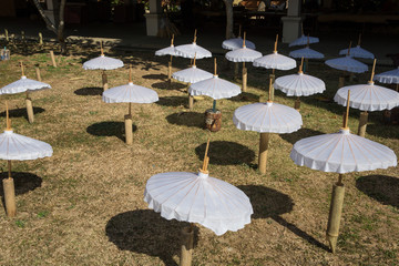 white umbrella placed for dring in sun