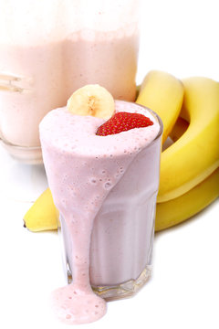 banana and strawberry smoothie on white background