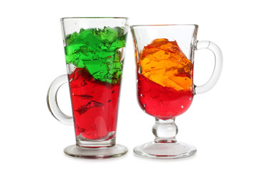 Glass jars with colorful cocktails on a white background