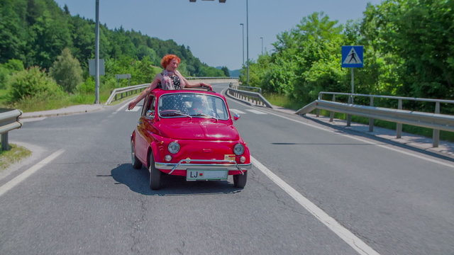Red yugo pulls back up to the main road