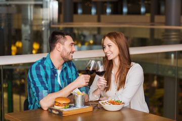 happy couple dining and drink wine at restaurant