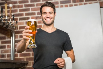 Handsome man holding a pint of beer