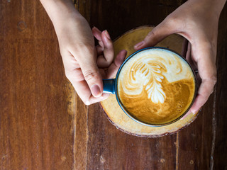 Woman hands holding mug of hot coffee drink