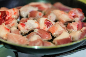 Raw pork on frying pan