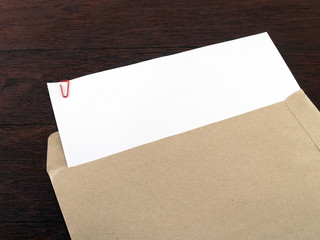 blank white paperwork with red clip in document envelope on desk floor