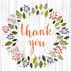 Thank you hand lettered text in calligraphic style. Botanical illustration of wreath. Vector.