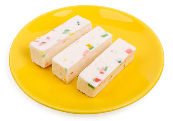 Fruit candy or pastila on a yellow saucer isolated on a white