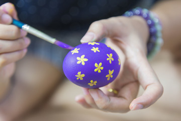the women painting the Easter egg for Easter holiday celebration