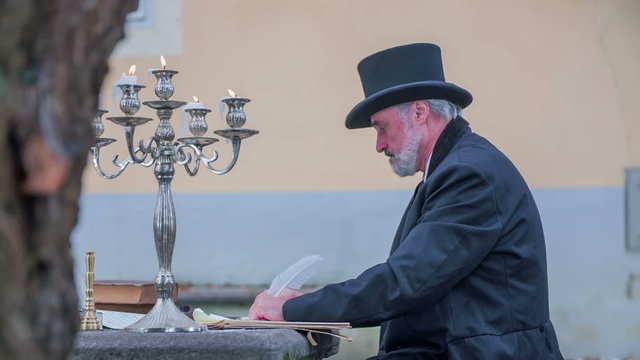 Man from Romantic times writing a latter 