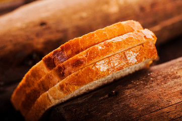 Fresh bread sliced on a wooden board