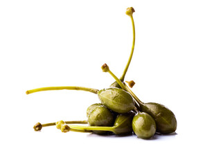 canned capers on white reflective background