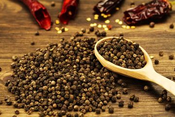 black pepper on old wooden table.