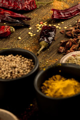 colorful spices and herbs on wooden table. Cutlery silhouette. Asian Indian cuisine ingredients. Healthy vegetarian food. Recipe, menu, mock up, cooking.