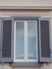 Window with grey shutters. Background.