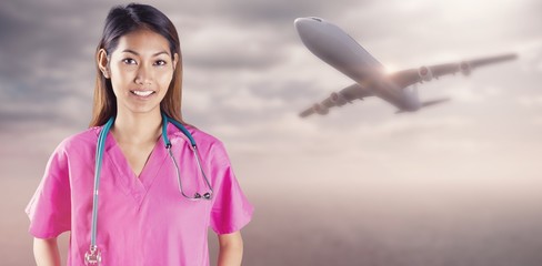 Composite image of asian nurse with stethoscope 