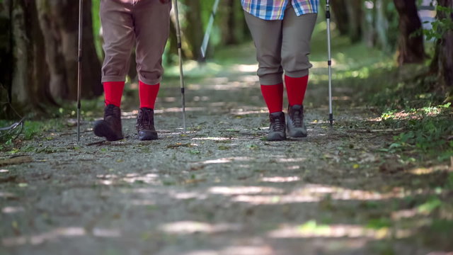 A video of two senior hikers' feet