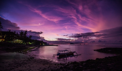 Indonesian tropical sunrise with the Venus visible and fisherman boat