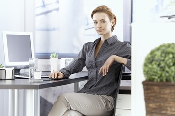 Attractive businesswoman sitting at desk