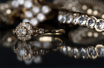 Gold jewelry with diamonds on blackboard. Gold diamond jewelry on a black background. Jewelry is...