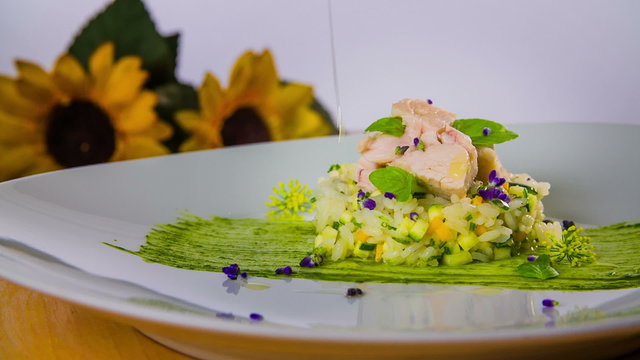 drops of oil on decorated plate of food for dinner