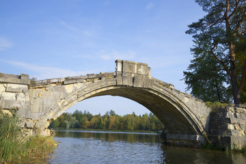 Fototapeta na wymiar In the arch of the Hunchback bridge september day. Gatchina palace park. Russia