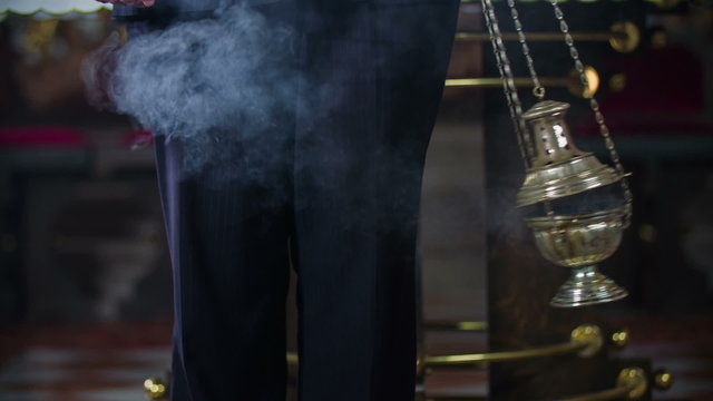 Priest swinging the thurmon 