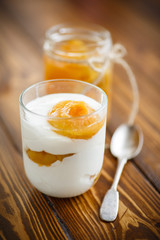 Greek yogurt with canned apricots in a glass 