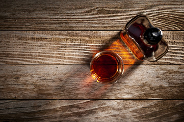 overhead view of a glass and bottle of whiskey