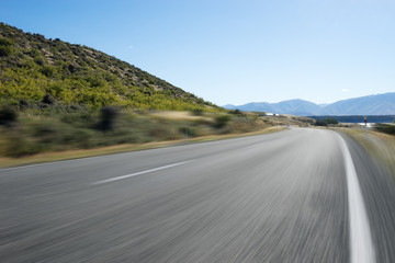 asphalt road near lake in summer day in New Zealand