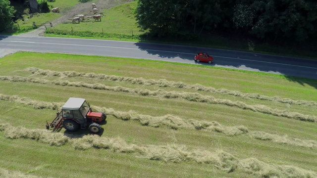 Red yugo passing a tractor