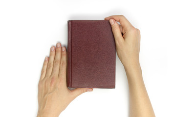 Hands hold blank red hardcover book on white background