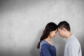 Composite image of loving couple head to head