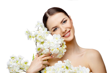 Beautiful Woman with Clean Fresh Skin holding flowering branches