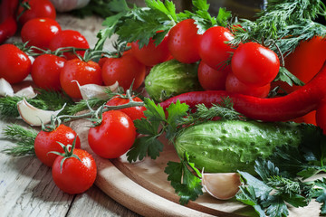 Fresh cherry tomatoes with spring vegetables and herbs, still li