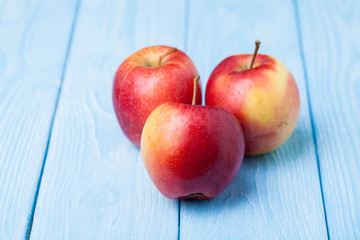 red apple placed the ball right on the wood floors, blue and white.
