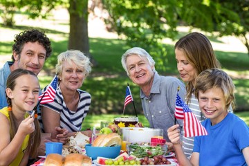 Family with American flag having a picnic