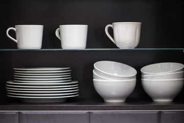 Fototapeta na wymiar Plates with cups in the cupboard